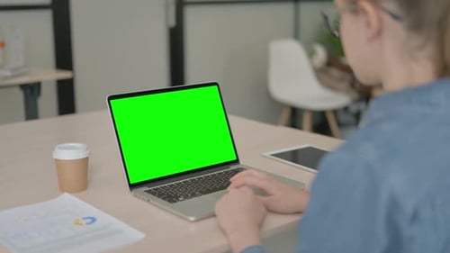 Young Woman Using Laptop with Green Screen
