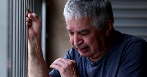 Crying older senior man. Depressed sad elder retired person