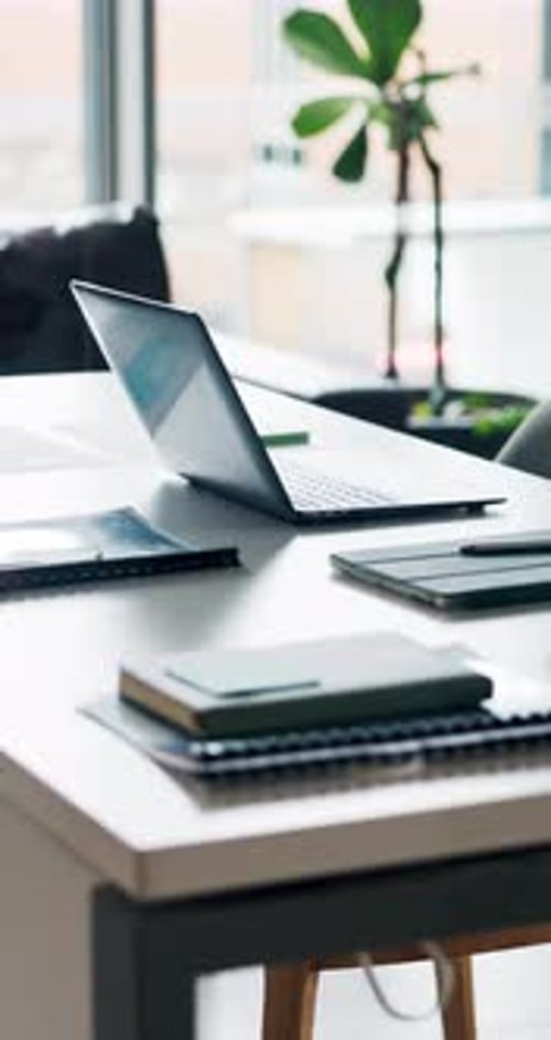 Laptop, office and documents with table of workspace of modern interior design or organised desk