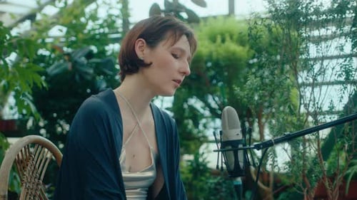 Woman Singing and Playing Keyboard in Garden Setting