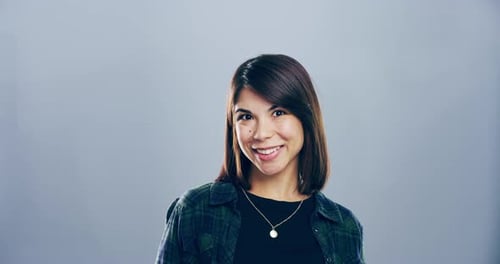 Smiling Woman Makes Heart Gesture