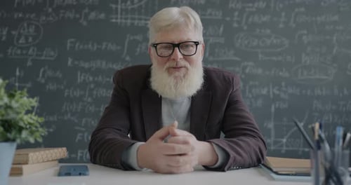 Mature Man Teaching Mathematics in a Classroom