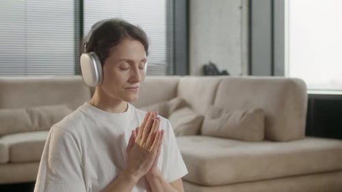 Woman Meditating with Headphones Indoors