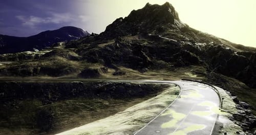 Winding Road Through a Dramatic Mountain Landscape During Golden Hour