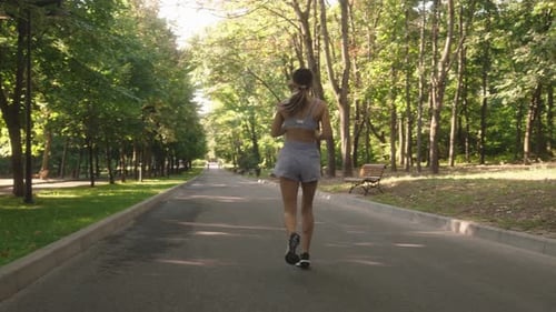 Fitness Woman Running In The Park
