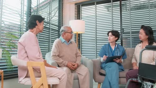 Caregiver Talking with Seniors in a Sunny Home