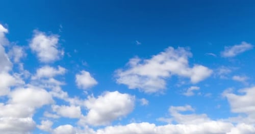 Fluffy soft white clouds moving by the azure skies. Cloudscape formation in the atmosphere.