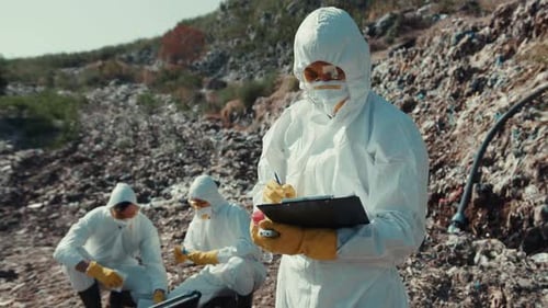 Scientists Analyze Waste at Polluted Landfill Wearing Protective Gear
