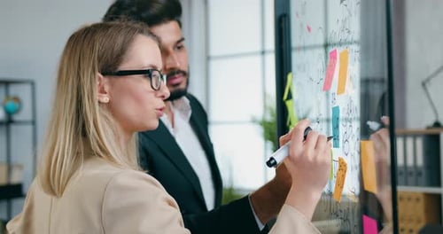 Colleagues collaborating on a project in modern office