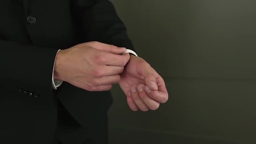 Man Adjusting His Shirt Cuff in Formal Wear