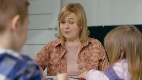 Portrait of a Teacher Who Tells Children How to Perform Tasks Correctly