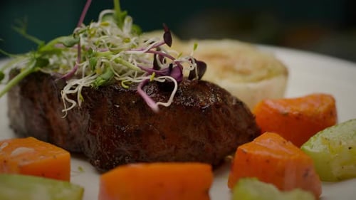 Beef Steak Served with Micro Green and Vegetables Rotating in Slow Motion Close Up