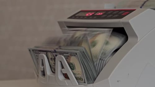 Money Counting Machine Processing Dollar Bills