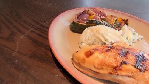 1-2 dolly diangle semi circle camera pan over mouth watering charbroiled bbq chicken with grilled ve