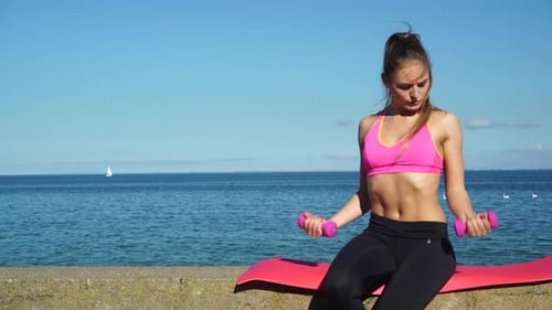 Woman Doing Sports With Dumbbells by Sea