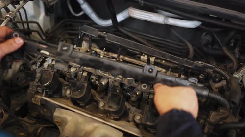 Close Up Hands of Unrecognizable Mechanic The Young Auto Mechanic Dismantles the