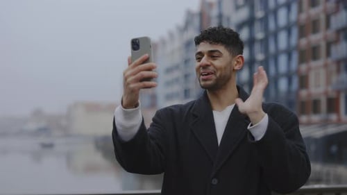 Multi Ethnic Man is Video Calling His Friends Standing Outside