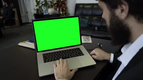 Office Worker Using Laptop with Green Screen
