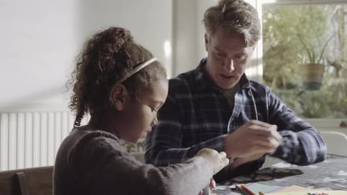 Girl Doing Arts and Crafts with an Adult