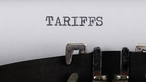 Close Up of "Tariffs" Being Typed on Typewriter