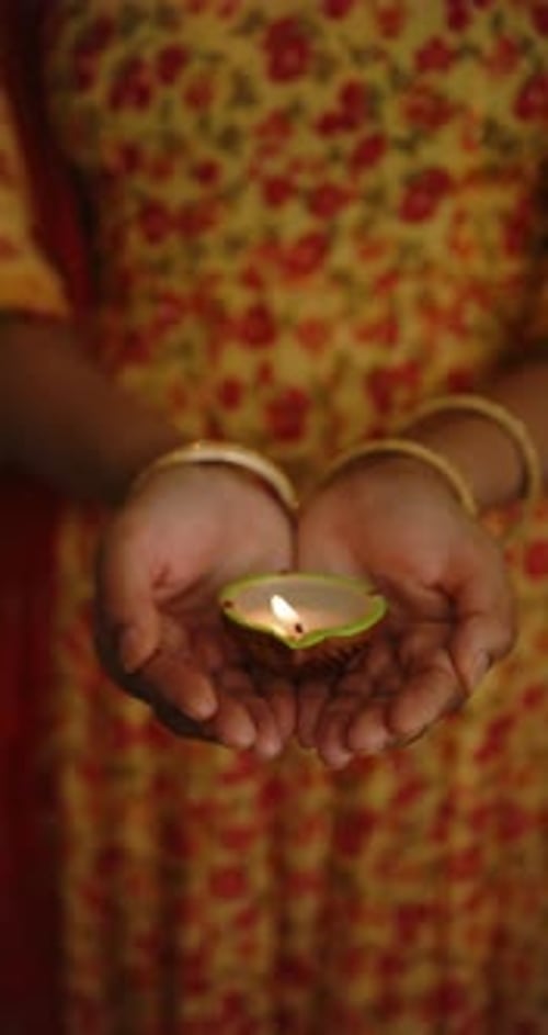Woman Holding Lit Diwali Diya Oil Lamp