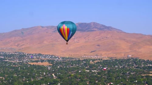 Hot air balloon soaring over downtown reno Nevada with casino views