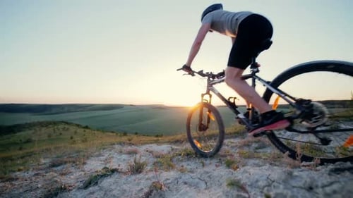 Rad vom Fahrrad kommt bei Sonnenuntergang in den Rahmen