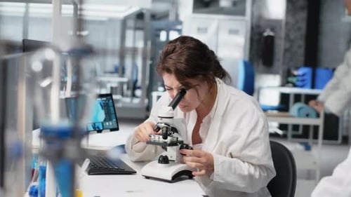 Clinical Lab Technologist Uses Scientific Microscope for Disease Detection