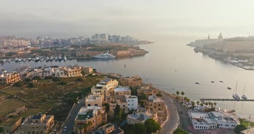 Breathtaking Aerial View of Malta Harbor at Sunset with Docked Yachts