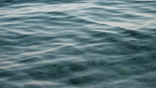 Slow motion of clear turquoise sea waves rolling on the beach.
