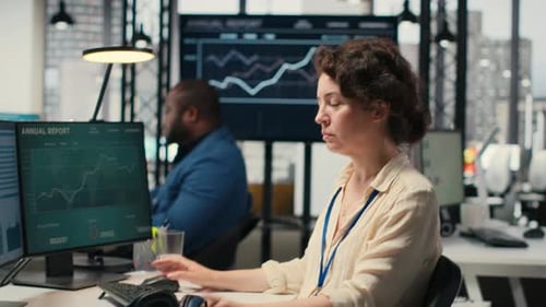 Young Businesswoman Focused on a Podcast While She Resolves Office Tasks