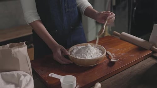 baker pour the mixture to hand make bread according formula at store