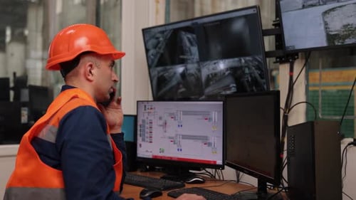 Engineer in Hardhat Speaking on the Phone at Desk
