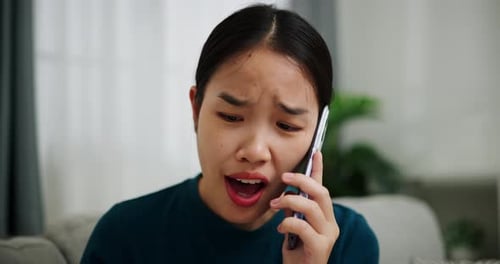 Woman Talking Angrily on Cell Phone Indoors