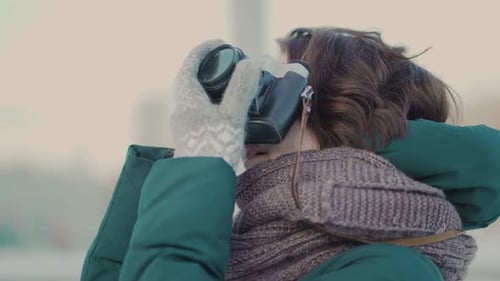 Woman Taking Pictures with Camera in City