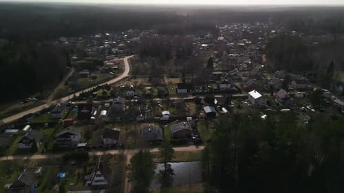 Birdseye View of a Town with Buildings Among Trees in a Forest Landscape