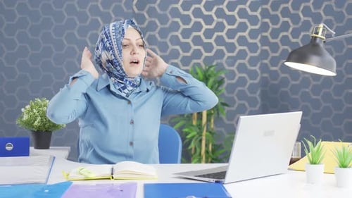 Hijab business woman shrinking and depressed at work.