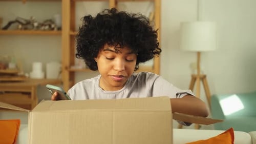 Woman with Curly Hair Opens Package at Home
