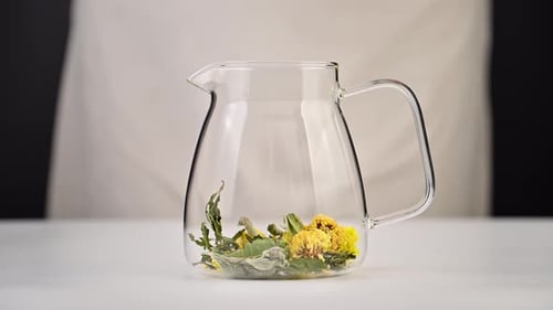Adding Herbal Tea Ingredients to Glass Pitcher