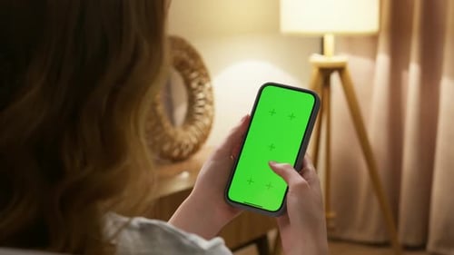 Woman Use Cell Mobile Phone with Green Chroma Key Screen Mock Up at Home