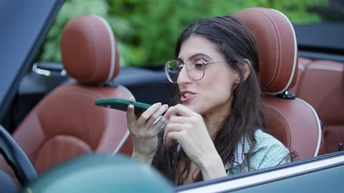 Woman Uses Voice Command on Smartphone in Car