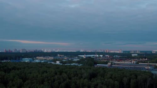 Timelapse Panoramic Cityscape with Forest and Urban Skyline at Sunset