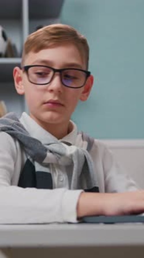 Boy Uses Tablet for Homework at Home