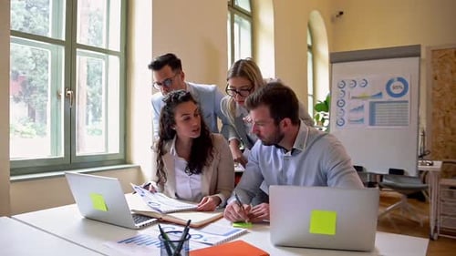 Group of business people working together while sitting at the office desk.