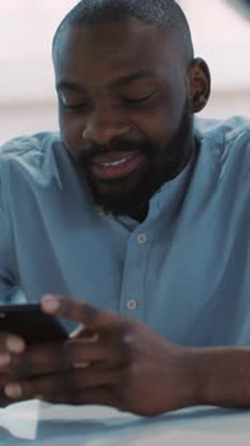 Man Using Cellphone Device Indoors