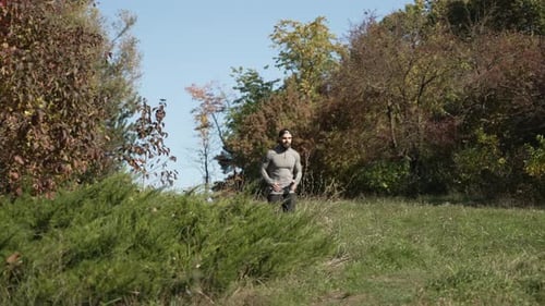 Man Running in a Grassy Field