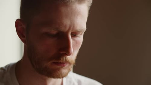 A Closeup of a Man with a Frown Looking Down Somewhere An Experienced Programmer is Focused on