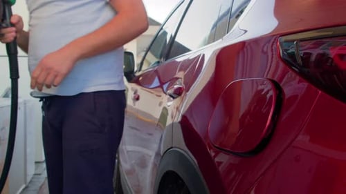 Anonymous Male Driver Refueling Car