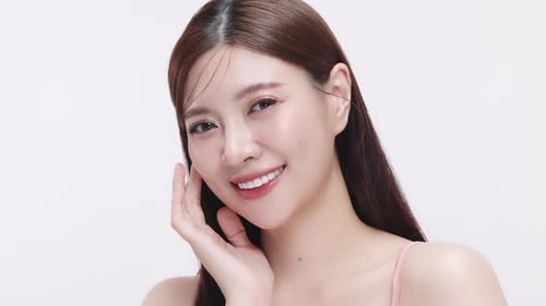 Slow motion shot Close up face of young beautiful young Asian woman with healthy and fresh skin.