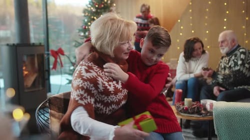 Boy Gives Christmas Present to His Grandmother